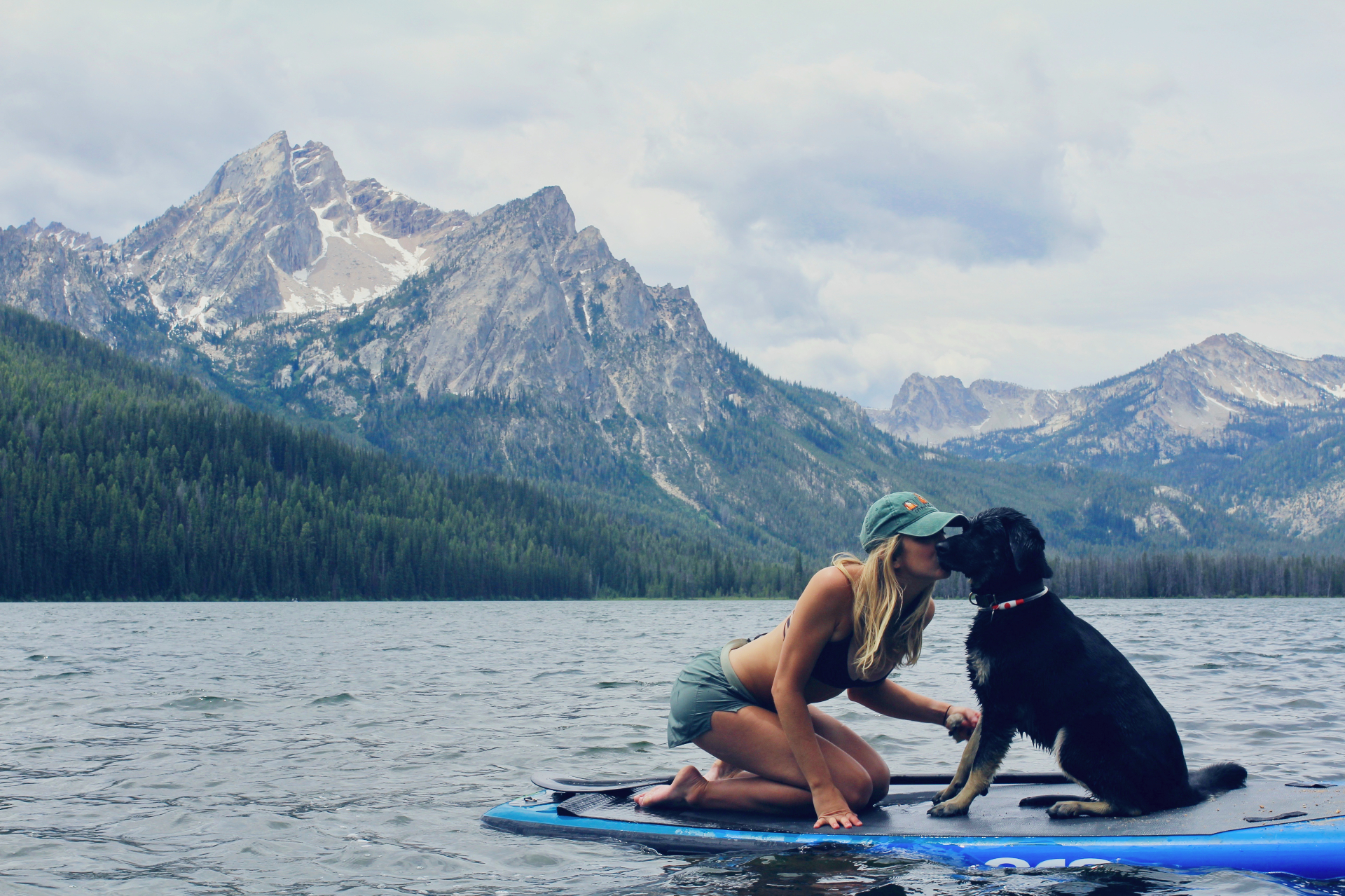 Girl with dog paddle boarding on Lake Tahoe