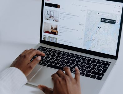 person using macbook pro on white table